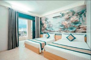 a bedroom with two beds and a mural of flowers at Chinh Thuỷ Hotel in Sầm Sơn