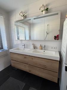 a bathroom with a large white sink and a mirror at Apartment Osso 3 in Arnhem