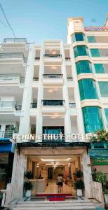 a large white building with a sign on it at Chinh Thuỷ Hotel in Sầm Sơn