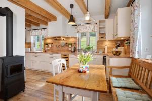 a kitchen with a wooden table and a stove at Villa Pauline in Baiersbronn