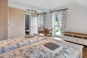 a bedroom with a bed and a chair and a window at Villa Pauline in Baiersbronn