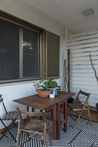 a wooden table and chairs on a patio at MAISON MI.RI' in Termoli