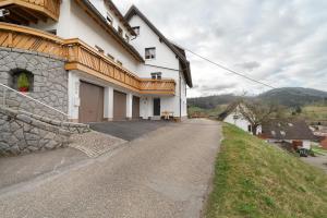 a house on a hill next to a road at Haus Am Schroffen in Ottenhöfen