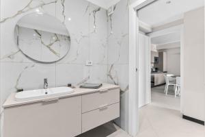 a white bathroom with a sink and a mirror at SeaFrontBonassola in Bonassola +190 photos