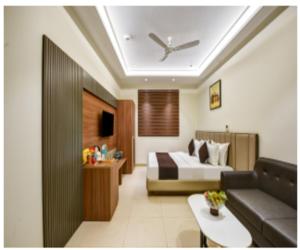 a hotel room with a bed and a couch at Hotel Heritage Suites in New Delhi