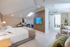 a bedroom with a large bed and a living room at Villa Delta - Parkhotel Delta in Ascona