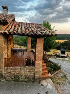 a gazebo with a table on a patio at El Ventador de la Torra in Lladurs