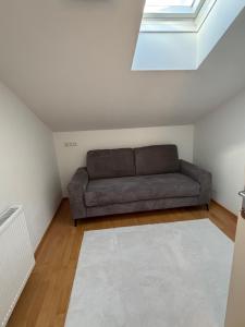 a living room with a couch and a skylight at Bergzauber in Bludenz