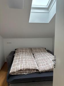 a bed in a room with a window at Bergzauber in Bludenz