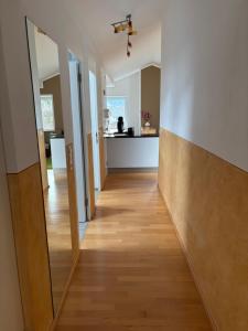 a hallway leading to a kitchen with a mirror at Bergzauber in Bludenz