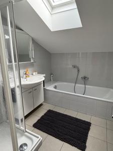 a bathroom with a shower and a tub and a sink at Bergzauber in Bludenz