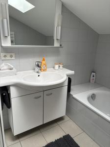 a bathroom with a sink and a bath tub at Bergzauber in Bludenz +49 photos