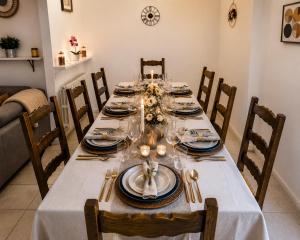 a dining room table with a white table cloth at Évasion Familiale à Essises - Proche des vignobles in Essises +9 photos