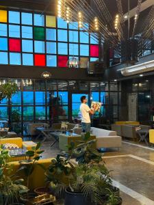 a man standing in a large room with tables and chairs at Mugwort Hotel & Spa in Istanbul +91 photos