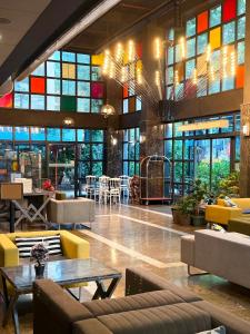 a lobby with colorful windows and couches and tables at Mugwort Hotel & Spa in Istanbul