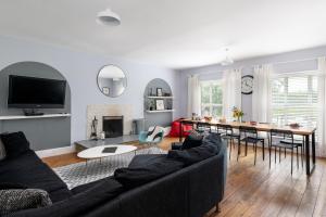 a living room with a couch and a table at Finest Retreats - Walltree House in Brackley