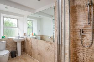 a bathroom with a shower and a toilet and a sink at Finest Retreats - Walltree House in Brackley +29 photos
