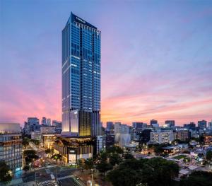 a tall building in a city at sunset at Conrad Nagoya in Nagoya