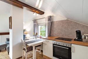 a kitchen with a sink and a stove at Schwarzwaldtani - Dörfle in Weier