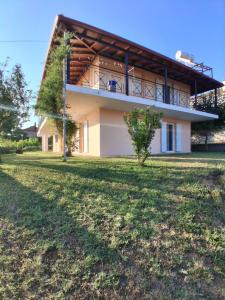 a house with a large yard in front of it at Οcalia Apartment in Petrokhórion