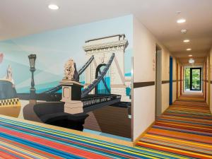 a hallway with a mural of a bridge at ibis Styles Budapest Citywest in Budapest