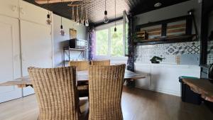 a dining room with a wooden table and chairs at Domaine Les Tourelles - Gîte 4 in Caffiers