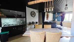 a kitchen and dining room with a table and chairs at Domaine Les Tourelles - Gîte 4 in Caffiers +20 photos