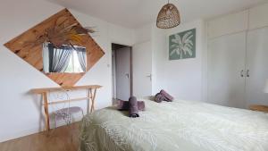 a bedroom with a bed and a desk and a window at Domaine Les Tourelles - Gîte 4 in Caffiers