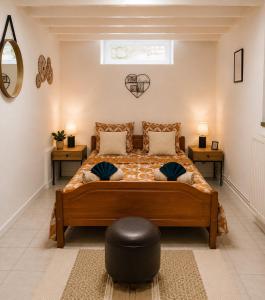 a bedroom with a bed with two tables and a mirror at Évasion Familiale à Essises - Proche des vignobles in Essises