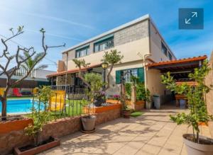 a house with a swimming pool and a building at Hostel Casa Lucas in Charneca