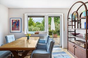a dining room with a table and chairs and a window at fewo-loh4-sinsheim in Sinsheim