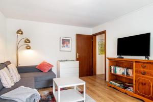 a living room with a couch and a flat screen tv at fewo-loh4-sinsheim in Sinsheim