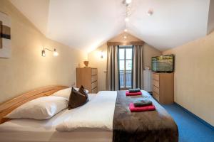 a bedroom with a large bed with two pillows on it at Appartements Lehenhof in Sankt Johann im Pongau