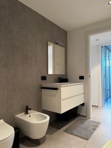 a bathroom with a sink and a toilet and a mirror at Villa Lavinia a Colico in Colico +25 photos