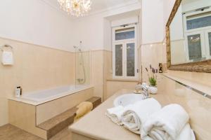 a bathroom with a bath tub and a sink at Luxury Seafront Apartment Banje in Dubrovnik +50 photos