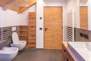 a bathroom with a toilet and a sink at Lüch dl Chessl - Kesslhof in San Martino in Badia +52 photos