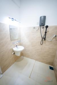 a bathroom with a sink and a mirror on the wall at Zen Nallur in Jaffna