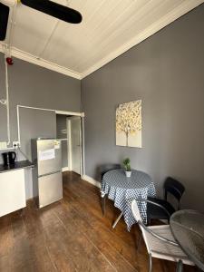 a kitchen with a table and a table and chairs at CapePod Sea Point in Cape Town