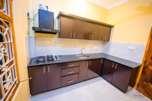 a kitchen with a sink and a counter top at Zen Nallur in Jaffna