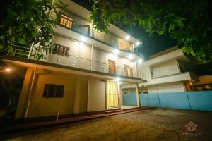 a white building with a balcony at night at Zen Nallur in Jaffna