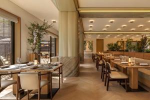 a restaurant with tables and chairs in a room at Capella Kyoto in Kyoto