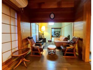a living room with a couch and chairs and a table at MAPLE HOUSE - Vacation STAY 13294v in Tsuru 