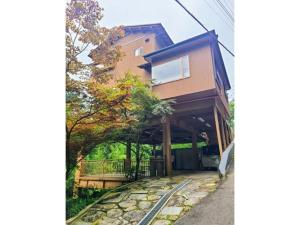 a house with a stone walkway next to a building at MAPLE HOUSE - Vacation STAY 13294v in Tsuru 