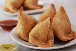 a plate of fried wontons with dipping sauce at Collection O Dandiya Bazar Formerly Vrundavan Residency in Vadodara