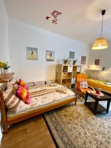 a bedroom with a bed and a living room at Apartmány u Litovelského Pomoraví in Olomouc