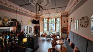 a bar with couches and chairs in a room at No32 Hotel in Edinburgh