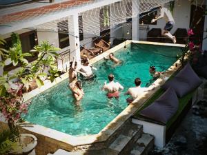 a group of people in a swimming pool at Gili Pirates Dive & Social Hostel in Gili Trawangan
