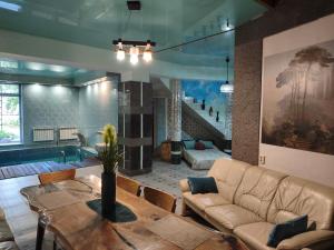 a living room with a couch and a table at Дом у моря с бассейном и сауной in Odesa