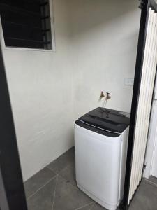 a bathroom with a toilet in the corner of a room at Savusavu Terraces - Unit 3 in Savusavu