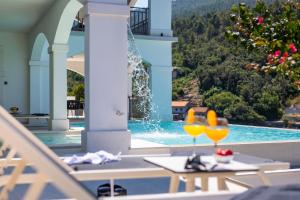 a view of a pool with two glasses on a table at Villa Christy in Čara
